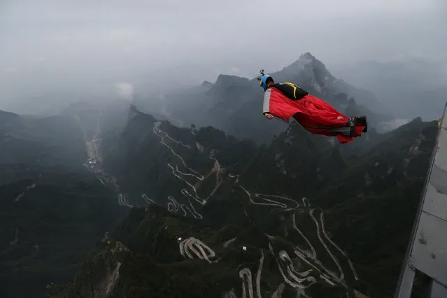A competitor participates in a wingsuit flying contest in Zhangjiajie, Hunan Province, China, October 13, 2016. (Photo by Reuters/Stringer)