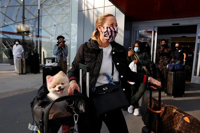 Stephanie Anderson and her companion, Gypsy, of Los Angeles, wait to depart Hartsfield-Jackson Atlanta International Airport ahead of the Thanksgiving holiday during the coronavirus disease (COVID-19) pandemic, in Atlanta, Georgia, U.S. November 23, 2020. (Photo by Chris Aluka Berry/Reuters)