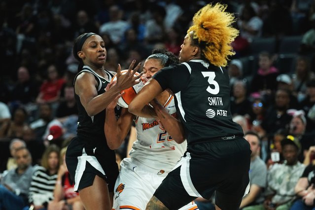 Phoenix Mercury forward Alyssa Thomas, center, is pressured by Las Vegas Aces forward NaLyssa Smith (3) and guard Jackie Young, left, during the first half in Game 1 of a WNBA basketball final playoff series Friday, October 3, 2025, in Las Vegas. (Photo by John Locher/AP Photo)