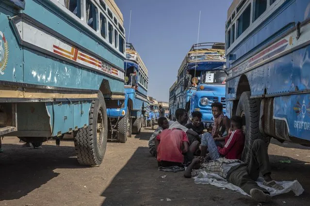 Tigray refugees who fled the conflict in the Ethiopia's Tigray wait to ride their bus going to the Village 8 temporary shelter, near the Sudan-Ethiopia border, in Hamdayet, eastern Sudan, Tuesday, December 1, 2020. (Photo by Nariman El-Mofty/AP Photo)