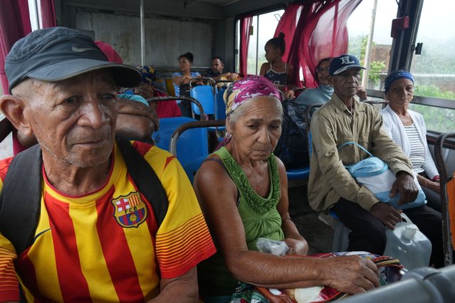 People wait inside a bus to be taken to a shelter ahead of Hurricane Melissa's landfall, in Caleta Blanca, Cuba, on October 28, 2025. (Photo by Alexandre Meneghini/Reuters)