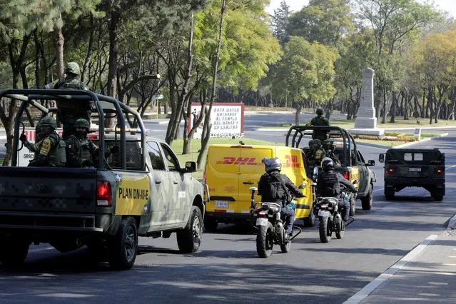 Soldiers and police officers escort a delivery van transporting the first batch of the Pfizer-BioNTech COVID-19 vaccine, as the coronavirus disease (COVID-19) outbreak continues, at the Military College in Mexico City, Mexico on December 23, 2020. (Photo by Luis Cortes/Reuters)
