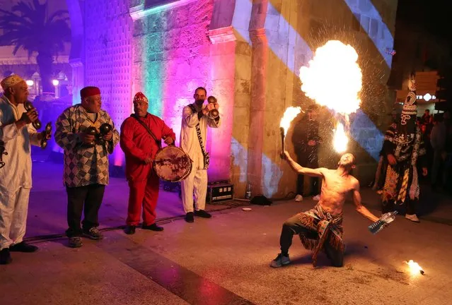 A member of the Soufi Stambali group spits fire during the second edition of the “Lighten Medina” festival in Tunis, Tunisia, 07 April 2023. The Lighten Medina festival was implemented by the Ministry of Tourism as part of the promotion of sustainable tourism projects in partnership with the Municipality of Tunis, the German Agency for International Cooperation, and the program “Tunis, our destination”. (Photo by Mohamed Messara/EPA)