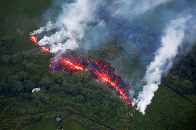 Lava erupts from a fissure east of the Leilani Estates subdivision during ongoing eruptions of the Kilauea Volcano in Hawaii, U.S., May 13, 2018. (Photo by Terray Sylvester/Reuters)