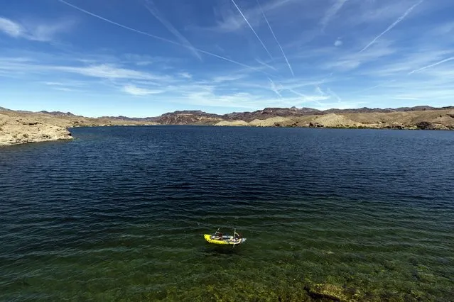 A photo taken with a drone shows people kayaking on the Colorado River, flowing south of the Hoover Dam near Boulder, Nevada, USA, 22 April 2023. Lake Mead water level is set to rise 33 feet higher than expected this year due to healthy snowpack levels in the upper Colorado River Basin according to the U.S. Bureau of Reclamation. Seven states (California, Nevada, Arizona, Utah, Wyoming, Colorado and New Mexico) rely on the water provided by the Colorado River which irrigates 5 million acres of farm land and on which 40 million people depend. The level of water available has dramatically dropped after years of severe drought which prompted the Biden administration, through the U.S. Bureau of Reclamation, to release an environmental impact statement draft that proposes to shave water deliveries to California, Nevada and Arizona by as much as one-fourth of what they currently receive. (Photo by Etienne Laurent/EPA)