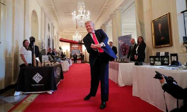 U.S. President Donald Trump swings a wooden baseball bat as he attends a “Spirit of America Showcase” event in the Cross Hall of the White House in Washington, U.S., July 2, 2020. (Photo by Tom Brenner/Reuters)