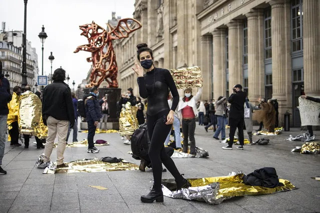 French cultural worker performs outside Gare du Nord train station during a demonstration flashmob in Paris, France, 01 February 2021. French cultural places remain closed in an attempt to combat spread of Covid-19 coronavirus pandemic. (Photo by Yoan Valat/EPA/EFE)
