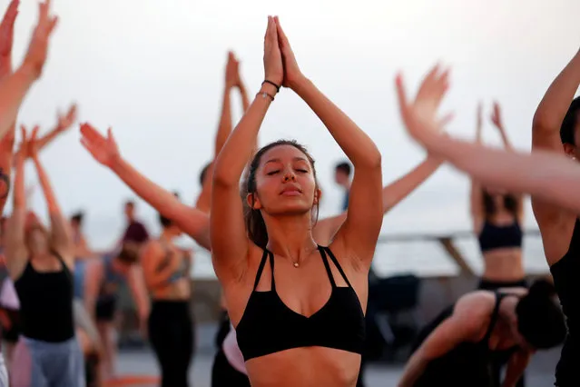 People practice Yoga on International Yoga Day in a port of Tel Aviv, Israel on June 21, 2018. (Photo by Corinna Kern/Reuters)