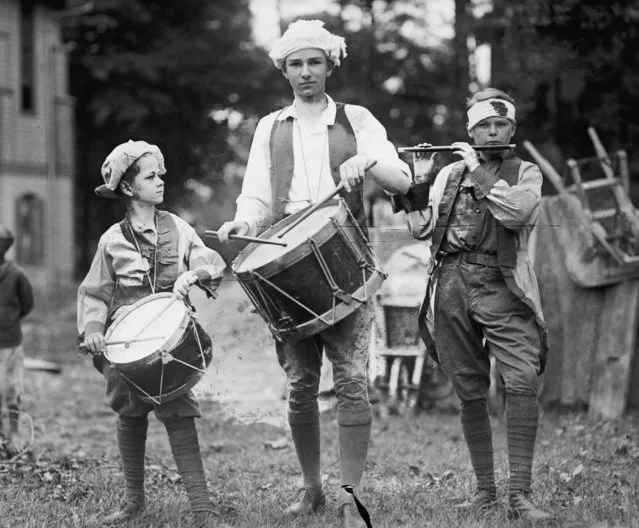 Three boys, dressed in colonial garb as the Spirit of 76, march with instruments during 4th of July celebrations, 1922. (Photo by Buyenlarge/Getty Images)