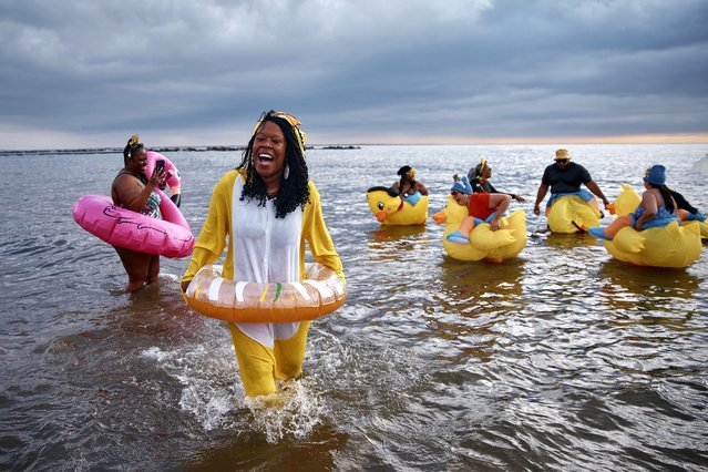 Revelers in costumes enter the cold water during the annual Polar Bear Plunge on New Year's Day, Wednesday, January 1, 2025, in New York. (Photo by Andres Kudacki/AP Photo)