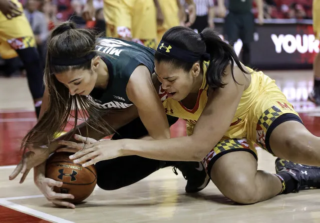 Michigan State guard Cara Miller, left, and Maryland center Brionna Jones struggle for possession of the ball during the first half of an NCAA college basketball game, Thursday, January 22, 2015, in College Park, Md. (Photo by Patrick Semansky/AP Photo)