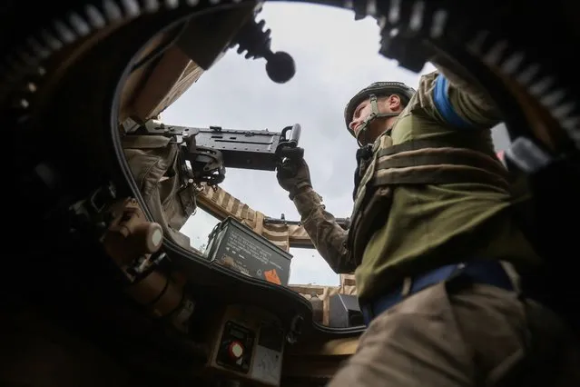 A Ukrainian serviceman mans a machine gun as he rides on a MaxxPro MRAP in the recently liberated village of Blagodatne, Donetsk region on June 16, 2023, amid the Russian invasion of Ukraine. Kyiv's forces are pushing onwards, and even the Russian army confirms that its positions in Urozhaine, another two kilometres south of Blagodatne, have come under attack. The push south in this valley is led by the experienced 68th Jaeger (Hunter) Brigade, and is the most concrete sign of Ukrainian progress since the wider offensive began. (Photo by Anatolii Stepanov/AFP Photo)