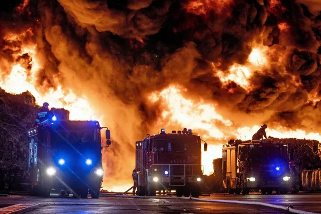 Emergency services respond to a fire at an illegal landfill site in Zgierz, near Lodz, central Poland, early 26 May 2018. According to media reports, almost 250 firefighters were trying to extinguish the hazardous fire of illegal waste in the landfill, which reportedly started on 25 May night. (Photo by Grzegorz Michalowski/EPA/EFE/Rex Features/Shutterstock)