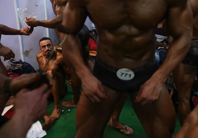 Bodybuilders prepare backstage for the men' s bodybuilding competition at the International Health, Sports and Fitness Festival in New Delhi on July 22, 2018 . The International Health, Sports and Fitness Festival, a B2 B fitness and wellness expo, runs from July 20 th to 22 nd 2018. (Photo by Sajjad Hussain/AFP Photo)