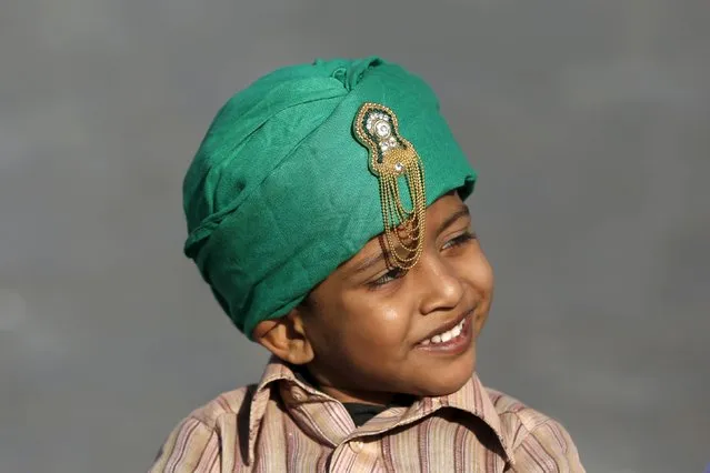 A boy sports a religious motif on his turban while taking part in a procession to mark Eid-e-Milad-ul-Nabi, or birthday celebrations of Prophet Mohammad, in Karachi, Pakistan, December 24, 2015. (Photo by Akhtar Soomro/Reuters)