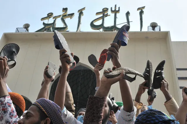 Thousands of Hifazat-e-Islam supporters gathered after the Jumma prayers at the National Mosque in Dhaka on March 19, 2021. With their shoes in their hands, they clapped and shouted, “Modi, you go back”, “Modi is a murderer”, “Modi has no entry in Bangladesh”. (Photo by MD Saiful Amin/Pacific Press/Rex Features/Shutterstock)