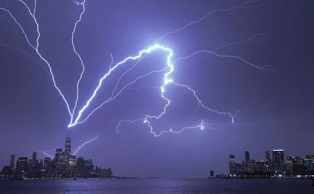 Lightning bolts strike One World Trade Center in New York City as it fans out over the Hudson River and Jersey City, New Jersey during a thunderstorm on April 1, 2023, as seen from Hoboken, New Jersey. (Photo by Gary Hershorn/Getty Images)