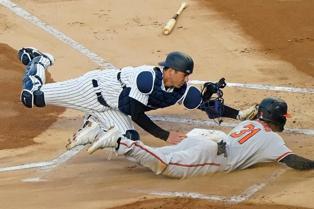 New York Yankees catcher Kyle Higashioka (66) tags Baltimore Orioles Cedric Mullins (31) out at the plate on a fielder's choice during the first inning of a baseball game, Tuesday, April 6, 2021, at Yankee Stadium in New York. Orioles Anthony Santander hit into the play. (Photo by Kathy Willens/AP Photo)