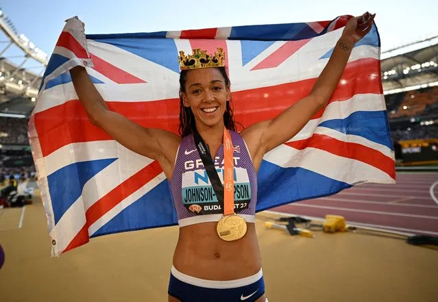 Katarina Johnson-Thompson of Team Great Britain celebrates with a crown and a Great Britain flag after winning gold in the Women's 800m Heptathlon final during day two of the World Athletics Championships Budapest 2023 at National Athletics Centre on August 20, 2023 in Budapest, Hungary. (Photo by Dylan Martinez/Reuters)