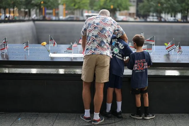 People look at the National September 11 Memorial & Museum, on the day of the 22nd anniversary of the September 11, 2001 attacks on the World Trade Center at the National September 11 Memorial & Museum, in New York City, U.S., September 11, 2023. (Photo by Andrew Kelly/Reuters)
