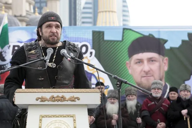 Russian biker group leader of Nochniye Volki (the Night Wolves), Alexander Zaldostanov, also known as Khirurg (the Surgeon) speaks to the crowd during a massive rally in Grozny, Russia, Friday, January 22, 2016. Tens of thousands of people have rallied in the capital of Russia's Chechnya Republic in support of strongman leader Ramzan Kadyrov and Russian President Vladimir Putin. (Photo by Musa Sadulayev/AP Photo)