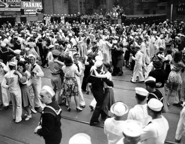 Members of the Army, Navy and Marines dance with young women who serve as United Service Organizations (USO) hostesses on La Salle Street in Chicago's financial district, Ill., June 7, 1942. (Photo by AP Photo)