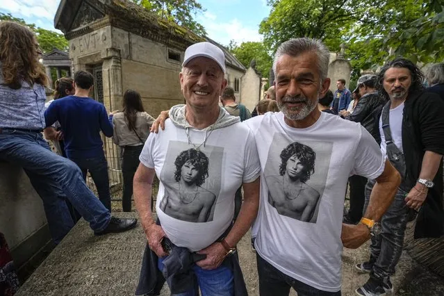 Fred Verheijden, left, and Hans van Schie of the Netherland wear shirts with the picture of late rock singer Jim Morrison at the Pere-Lachaise cemetery in Paris, Saturday, July 3, 2021. Fans across Europe gathered at the grave of rock legend Jim Morrison to mark the 50th anniversary of his death. (Photo by Michel Euler/AP Photo)