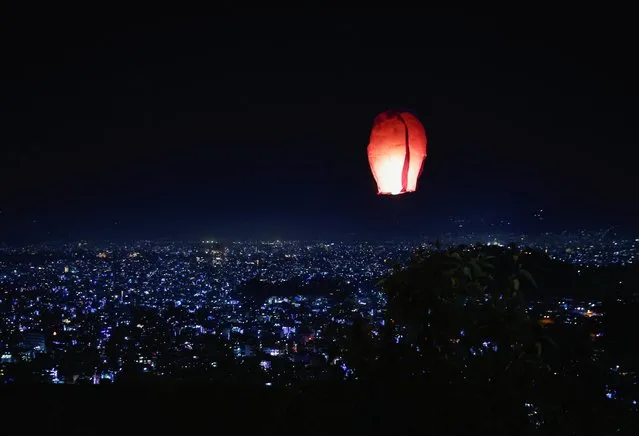 A flying lantern hovers above the skyline of Kathmandu valley during the Tihar festival, the Hindu festival of lights in Kathmandu, Nepal on October 23, 2022. (Photo by Navesh Chitrakar/Reuters)