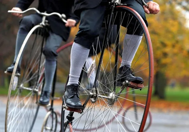 Participants wearing historical costumes ride their high-wheel bicycles during the annual penny farthing race in Prague, Czech Republic on November 5, 2022. (Photo by David W. Cerny/Reuters)