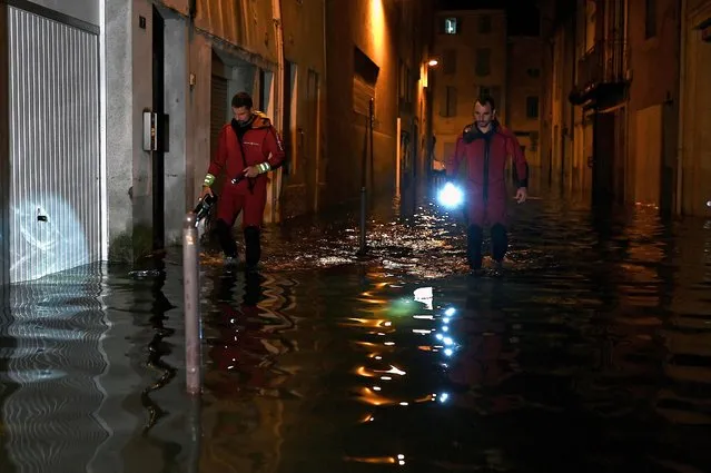 French firefighters inspect a flooded street after heavy rain in Agen, southwestern France on September 8, 2021. (Photo by Philippe Lopez/AFP Photo)