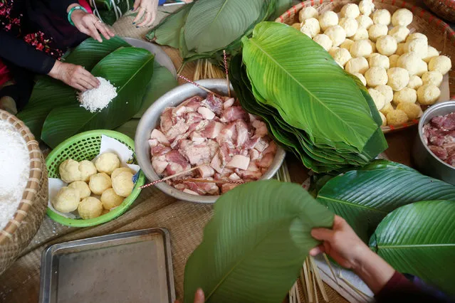 Residents gather to make banh chung or rice cake in preparation for Tet, the lunar new year festival which will take place from January 28, at a village in Hanoi January 22, 2017. (Photo by Reuters/Kham)