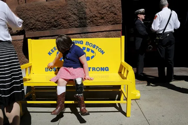 Jane, the sister of Boston Marathon bombing victim Martin Richard, sits on a new bench with the words “Keep Running Boston” and “Boston Strong” on it outside the fire station on Boylston Street on the second anniversary of the Boston Marathon bombings in Boston, Massachusetts April 15, 2015. (Photo by Brian Snyder/Reuters)