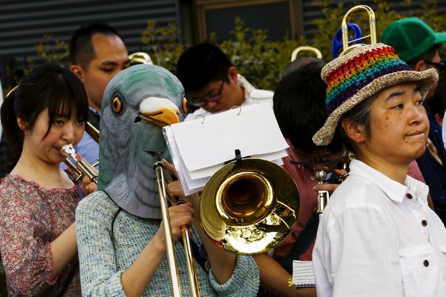 A woman wears a bird mask as she pays a trombone during the Tokyo Rainbow Pride parade in Tokyo April 26, 2015. (Photo by Thomas Peter/Reuters)