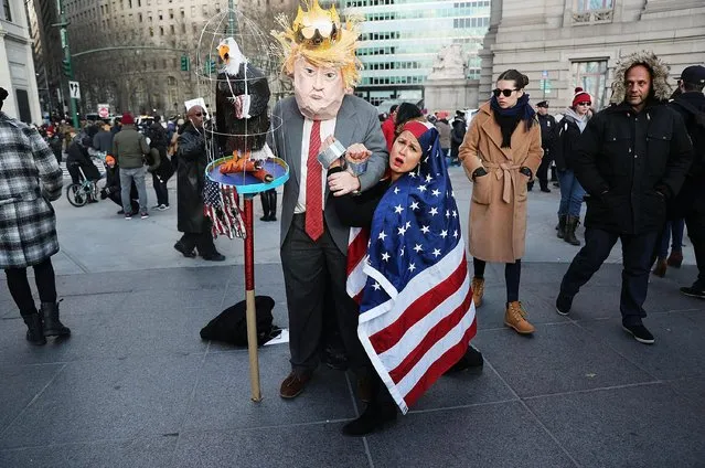 Protesters pause while attending arally in lower Manhattan to protest President Donald Trump's new immigration policies on January 29, 2017 in New York City. Trump's executive order on immigration has created chaos and confusion among many Muslims as it temporarily bars citizens from seven largely Muslim countries, as well as all refugees, from entering the U.S. (Photo by Spencer Platt/Getty Images)