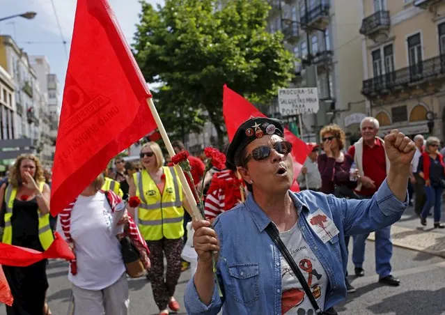 Workers shout slogans against austerity measures during a march by the Portuguese union CGTP in Lisbon May 1, 2015. (Photo by Hugo Correia/Reuters)