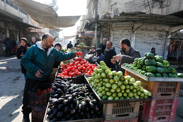An Iraqi man buys vegetables after returning to his home in Mosul, Iraq, February 3, 2017. (Photo by Ahmed Saad/Reuters)