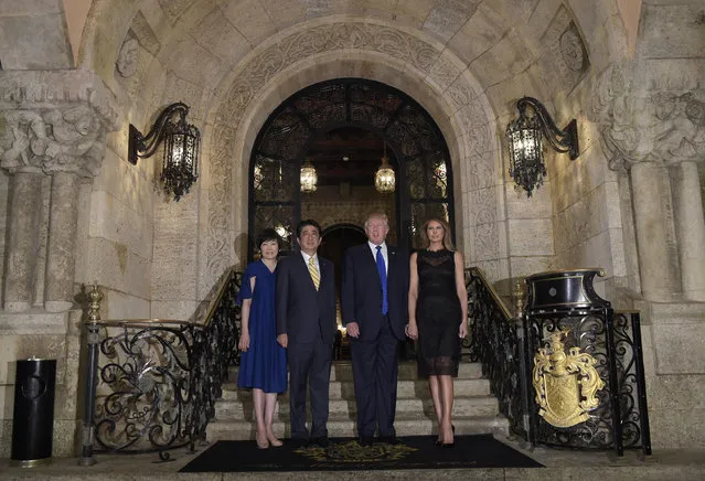 President Donald Trump, second from right, and first lady Melania Trump, right, stop to pose for a photo with Japanese Prime Minister Shinzo Abe, second from left, and his wife Akie Abe, left, before they have dinner at Mar-a-Lago in Palm Beach, Fla., Saturday, February 11, 2017. (Photo by Susan Walsh/AP Photo)