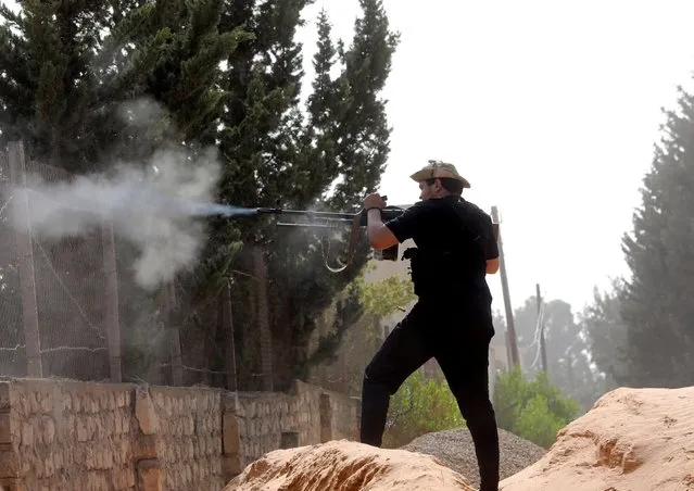 A member of the Libyan internationally recognised government forces fires during a fight with Eastern forces in Ain Zara, Tripoli, Libya April 25, 2019. (Photo by Hani Amara/Reuters)