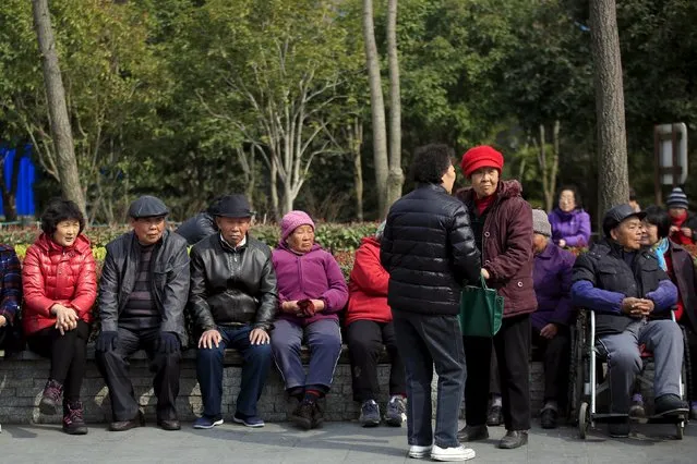 Elderly people enjoy the sunshine at an old residential site in Shanghai, China, March 14, 2016. (Photo by Aly Song/Reuters)
