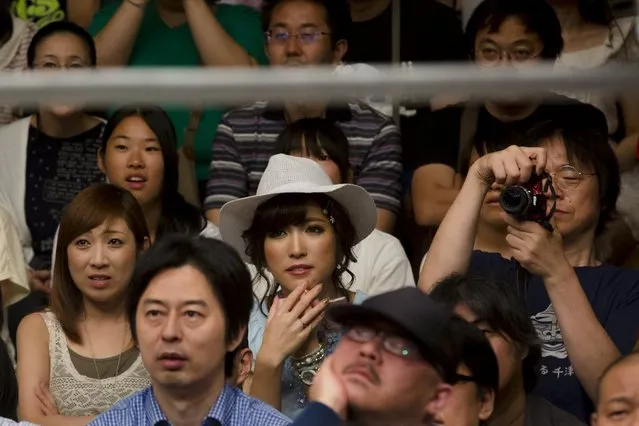 People watch women fight during a Stardom female professional wrestling show at Korakuen Hall in Tokyo, Japan, July 26, 2015. (Photo by Thomas Peter/Reuters)