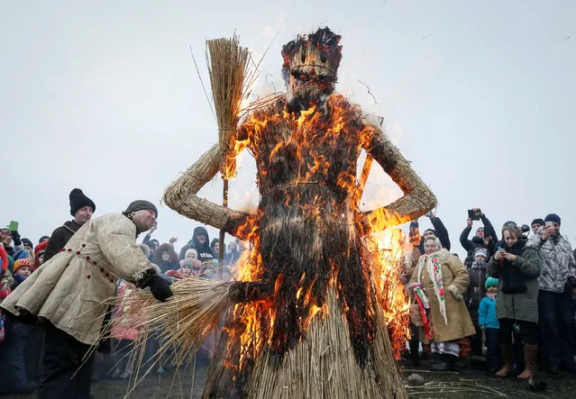 Revellers burn an effigy of Kostrubatyi Did, a symbol of winter, during the celebration of Maslenitsa also known as Kolodiy, a pagan holiday marking the end of winter, in Kiev, Ukraine, February 26, 2017. (Photo by Vasily Fedosenko/Reuters)