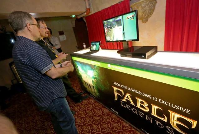 Gamers check out game streaming with the Xbox App on Windows 10 at the Xbox-sponsored PC Gaming Show at E3 in Los Angeles on Tuesday, June 16, 2015. (Photo by Casey Rodgers/Invision for Microsoft/AP Images)