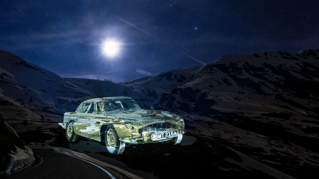 Swiss light artist Gerry Hofstetter illuminates the snow walls and mountains of the Furka Pass in Andermatt Swiss Alps to commemorate the iconic car chase scene from James Bond's Goldfinger, which took place in the town 60 years ago this summer on April 13, 2024 in Andermatt, Switzerland. The 300m projection series marks the start of the 60th anniversary celebrations in Andermatt which include a film festival, a special showcase of the original Aston Martin DB5 Vantage driven by Sean Connery, an exhibition of archive materials from the movie, opportunities to drive the Pass and outdoor mountaintop screenings of the movie. (Photo by Philipp Schmidli/Getty Images for Andermatt Swiss Alps)