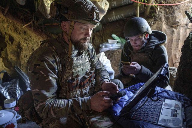 Ukrainian serviceman Andrii, left, of the  Air Assault Forces 148th separate artillery brigade,  sends receiving coordinates for a Furia drone at the frontline in Donetsk region, Ukraine, Thursday May 9, 2024. (Photo by Evgeniy Maloletka/AP Photo)