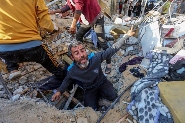 A Palestinian man reacts as he searches for casualties at the site of an Israeli strike on a house, amid the ongoing conflict between Israel and the Palestinian Islamist group Hamas, in Nuseirat refugee camp in the central Gaza Strip, on May 14, 2024. (Photo by Ramadan Abed/Reuters)