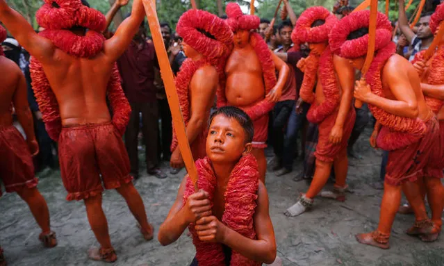 Hindu devotees dance as they take part in a festival called Lal Kach (Red Glass) during the last day of the Bangla month in Munshigonj, Dhaka, Bangladesh on April 13, 2017. (Photo by Mushfiqul Alam/ZUMA Wire/Rex Features/Shutterstock)