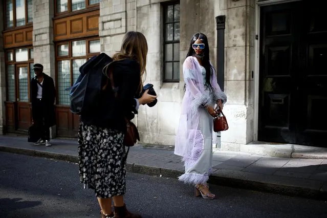 A photographer takes pictures of people outside a venue at London Fashion Week in London, Britain, September 17, 2019. (Photo by Henry Nicholls/Reuters)