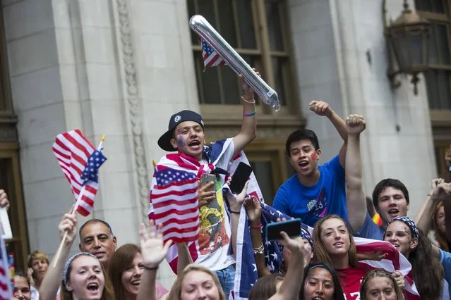 Fans of the U.S. women's soccer team cheer during the ticker tape parade to celebrate their World Cup final win over Japan on Sunday, in New York, July 10, 2015. (Photo by Andrew Kelly/Reuters)