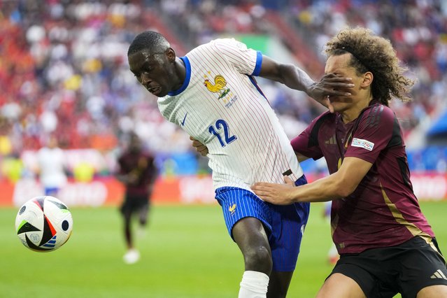 Randal Kolo Muani of France fights for the ball with Belgium's Wout Faes, right, during a round of sixteen match between France and Belgium at the Euro 2024 soccer tournament in Duesseldorf, Germany, Monday, July 1, 2024. (Photo by Darko Vojinovic/AP Photo)