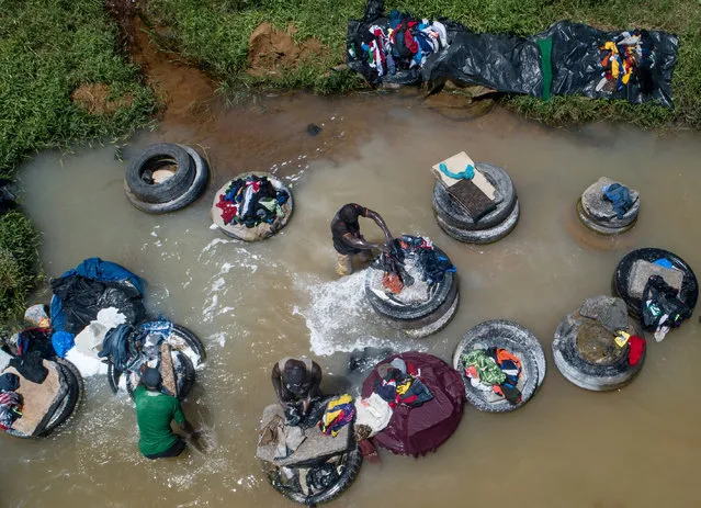 Laundrymen also called “Fanico” do other people's laundry at the stream in Banco National Park to earn their livings in Abidjan, Ivory Coast on August 20, 2019. (Photo by Mahmut Serdar Alaku/Anadolu Agency via Getty Images)